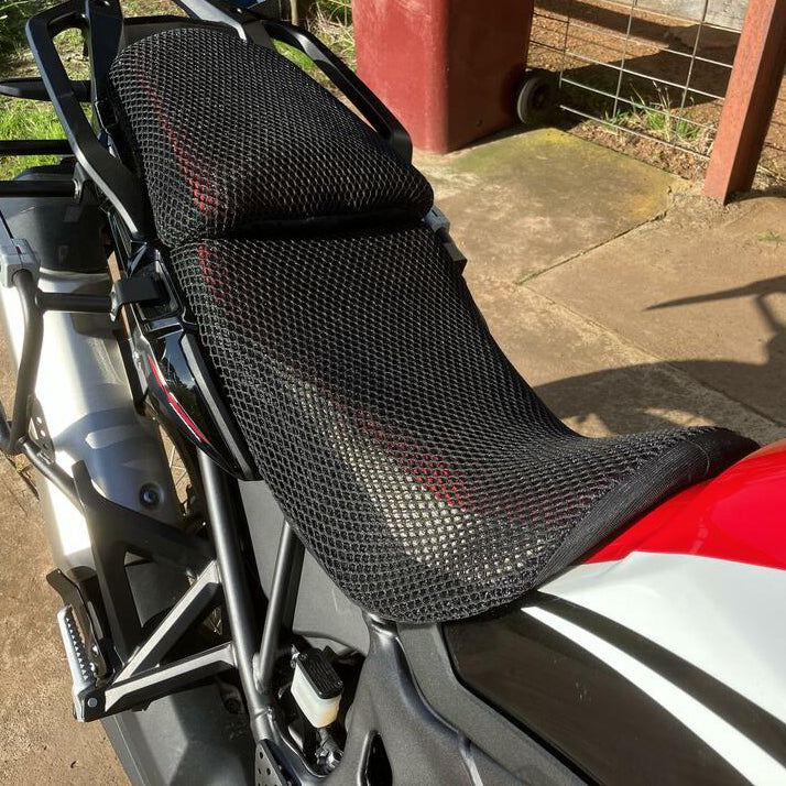 Cool Dry Covers seat covers to fit your Honda Africa Twin (pictured).  Keeps you raised off the original seat, much cooler in the heat and allows air circulation.  Water goes through without being absorbed so you stay drier in the wet.  These are sized to fit your specific seat perfectly.  Transform your ride with Cool Dry Covers.